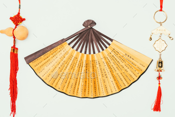 top view of traditional chinese handheld fan with talismans isolated on white