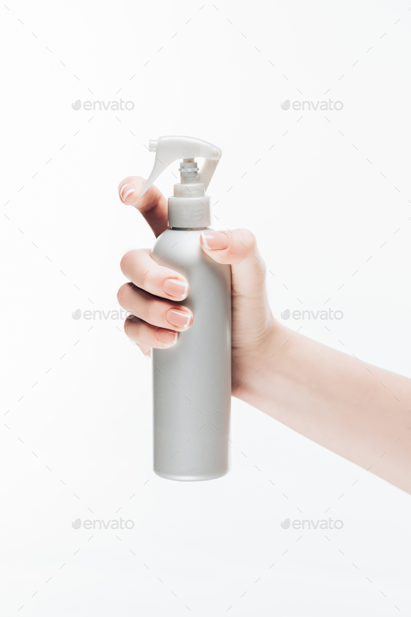 cropped shot of woman holding blank cosmetic spray bottle isolated on white