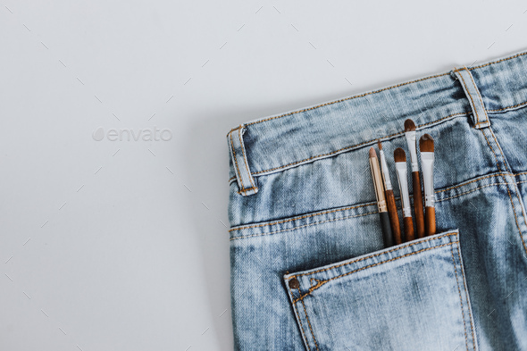 Cosmetic brush set in denim pants pocket