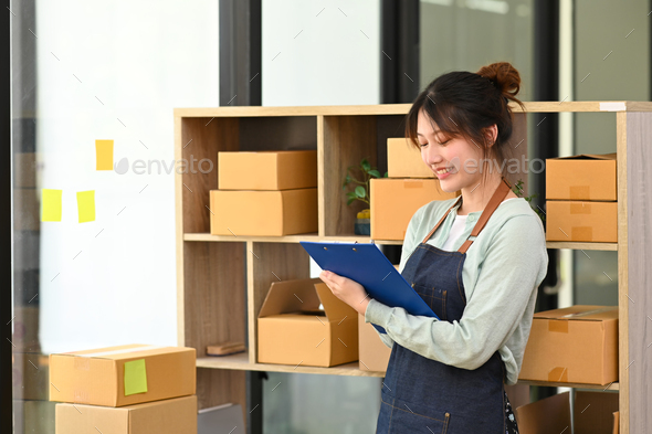 Small businesses owner in apron working at drop shipping business office.