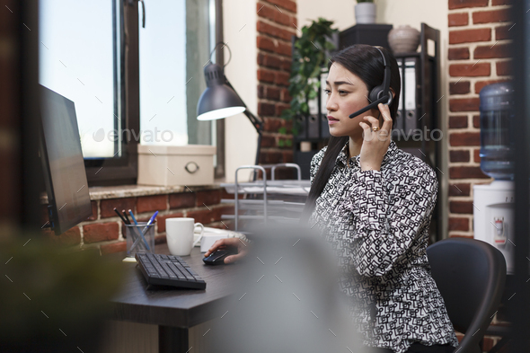 Customer service operator trying to solve client account issue while sitting in company workplace