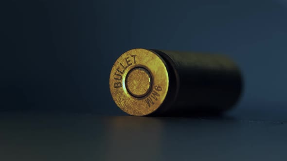 Close-up of falling 9mm bullet shells. Military, crime, weapon concept. alt