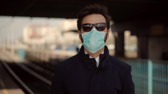 Man In Face Mask Coronavirus Covid19. Medical Mask Coronavirus.Man Waiting Tram.Epidemic. alt
