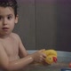 Boy Playing with a Yellow Rubber Duck Toy While Taking a Bath - VideoHive Item for Sale