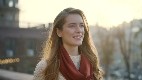 Sweet Woman Smiling on Street. Portrait of Cheerful Girl Walking Outdoors. alt