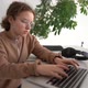 Closeup Shot of a Serious Teen Girl Thoughtfully Looking to a Laptop Screen and Typing - VideoHive Item for Sale