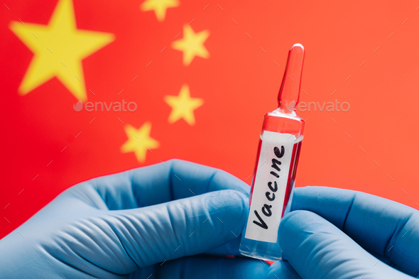 Coronavirus treatment concept. Vaccine for Covid-19 against Chinese flag