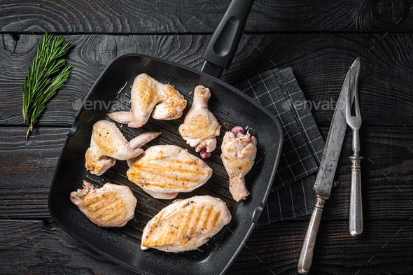 Roasted on a grill skillet chicken meat and chicken parts - drumstick, breast fillet, wing, thigh. B