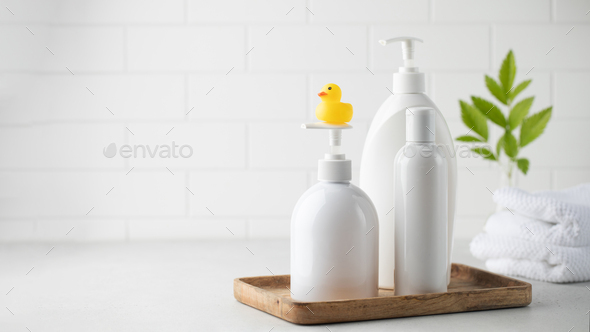 Blank plastic dispenser bottles with soap and shampoo for everyday in bathroom.