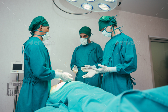 Team of surgeon preparing before surgery in operating theatre room