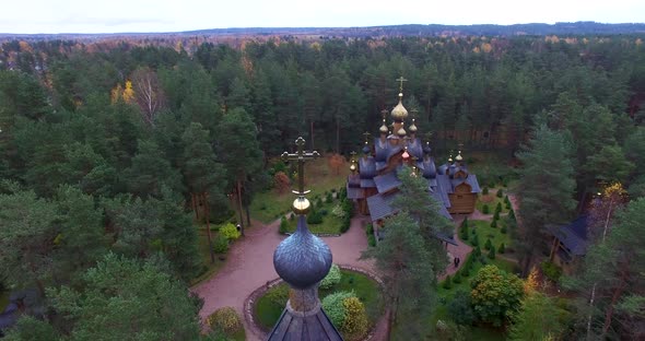 Orthodox Church with Golden Domes in the Middle of the Forest