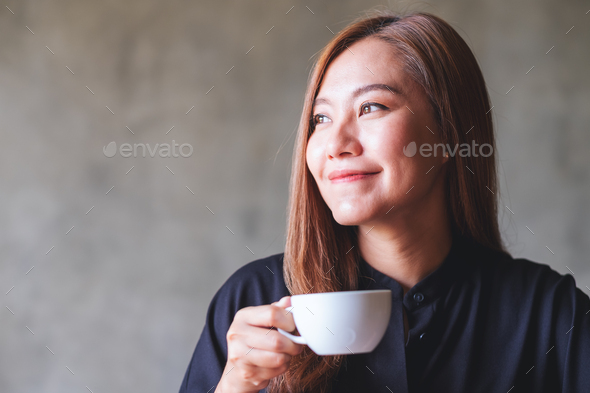 Portrait image of a beautiful young asian woman holding and drinking ...