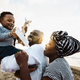 Happy African family having fun on the beach during summer vacation - Parents love and unity concept - PhotoDune Item for Sale