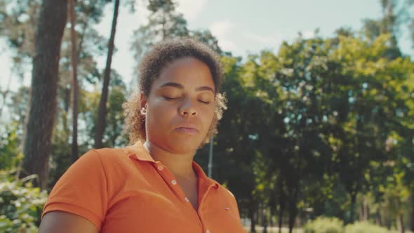 Young Adult Woman Expressing Facial Emotion of Sadness Outdoors alt