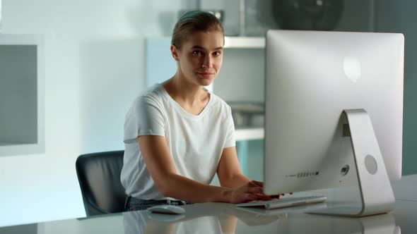 Smiling Woman Using Desktop Computer at Home Office alt