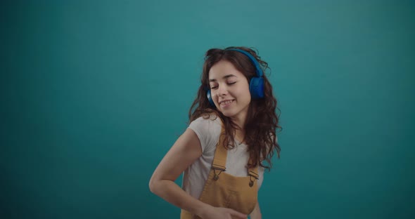 Happy Girl is Dancing and Singing in Headphones