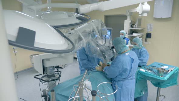Top View of an Operating Process Performed By a Group of Surgeons alt