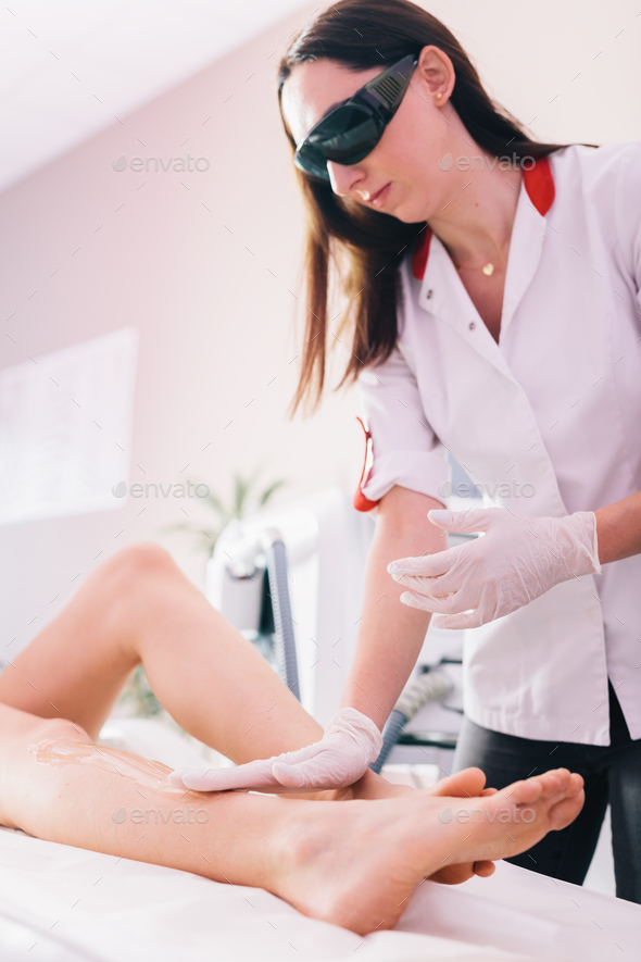 Woman on laser hair removal treatment on leg, applying gel Stock Photo by  photocreo