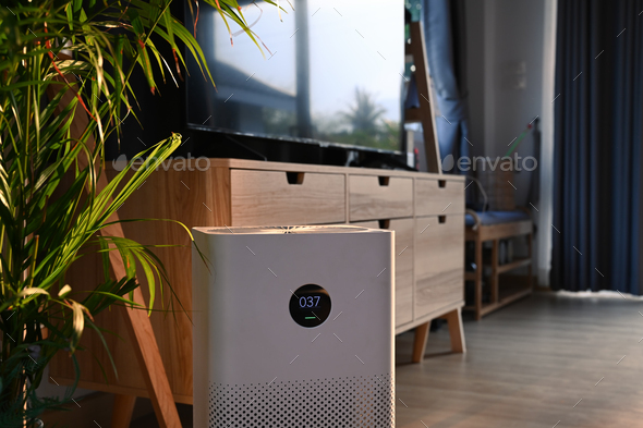 Close up view of portable air purifier on wooden floor in comfortable home for improve air quality.