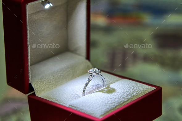 Jewelry production. White gold diamond ring in ice-lit gift box. Wedding, engagement, marriage