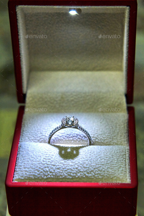 Jewelry production. White gold diamond ring in ice-lit gift box. Wedding, engagement, marriage