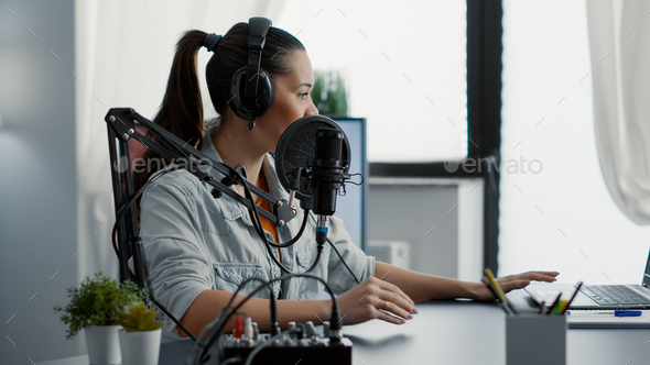 Creative podcaster hosting internet live talk show while sitting in studio