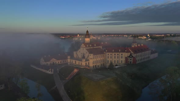 Amazing Dawn in the Foggy Nesvizh Fog Over the River