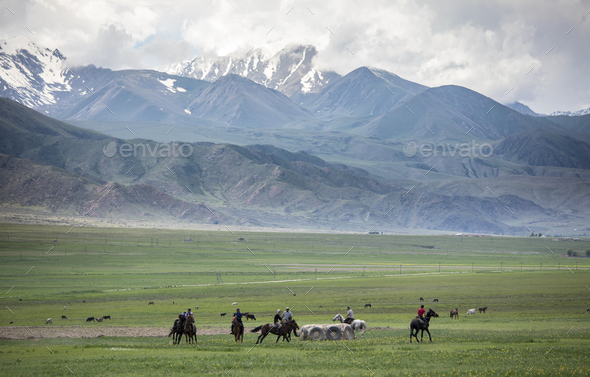 Men play a game of Kok Boru, or dead goat polo, in the mountains of Kyrgyzstan. - Stock Photo - Images