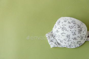 Beautiful bra on an olive background. The concept of clothing, shopping, lingerie.