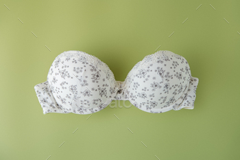 Beautiful bra on a light green background. The concept of clothing, shopping, lingerie.