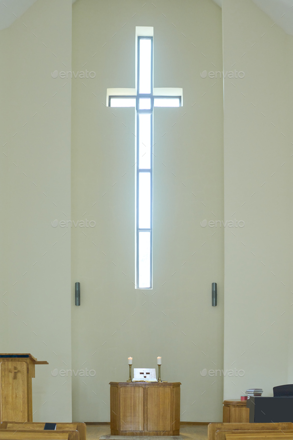 Empty service hall in modern catholic or evangelical church with cross on wall