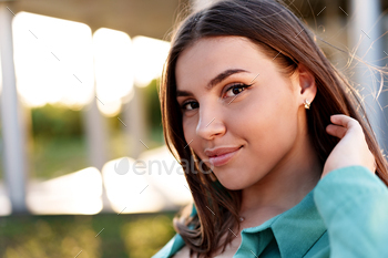 Close up portrait of a young smiling brunette woman