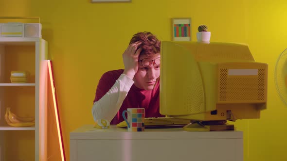 Man IT Specialist Is Feeling Tired Working at Computer