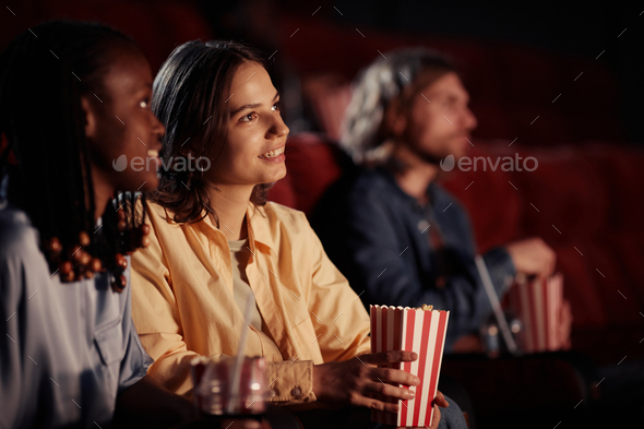 Girl watching movie with her friend