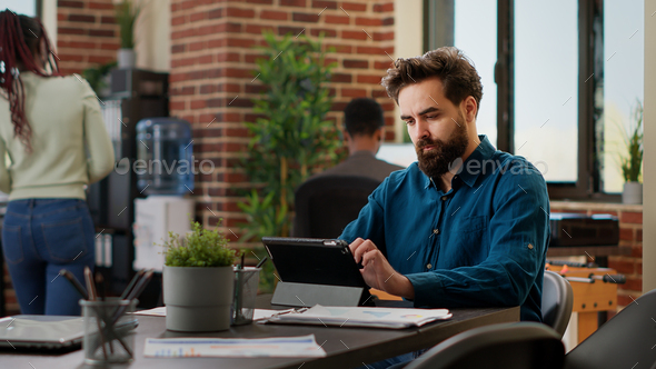 Business man working on digital tablet to send email