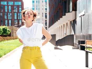 Young beautiful hipster girl posing outdoors