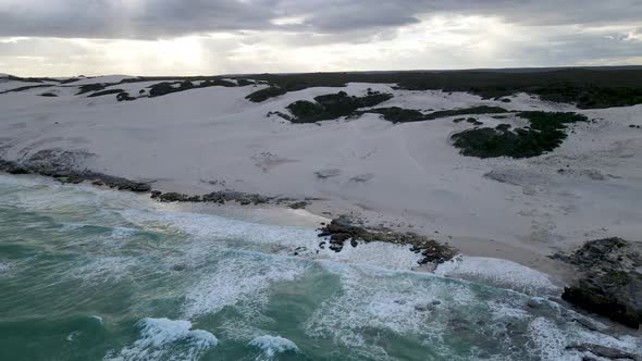 Aerial view of remote beach with man walking, Western Cape, South Africa. alt