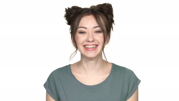Portrait of Hilarious Woman with Double Buns Hairstyle Making Faces and Grimacing with Showing alt