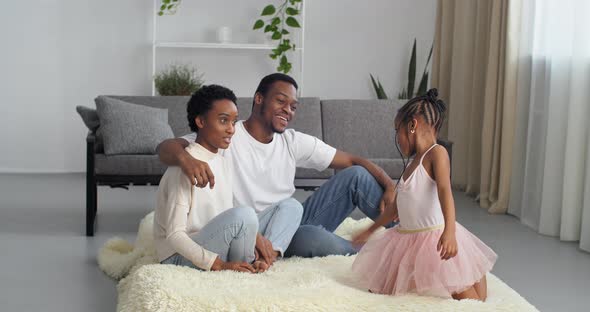 Afro American Family with Daughters in Princess Dress Spend Time Together in New House Renters  alt