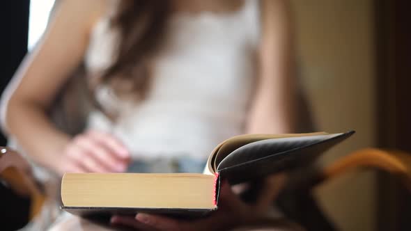 Flipping a book page, close-up alt