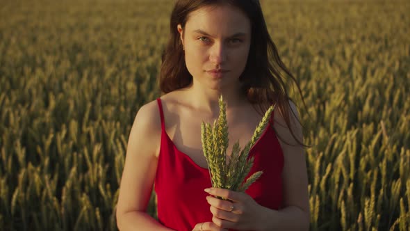 Beautiful Girl Holding Wheat Ears in Her Hand