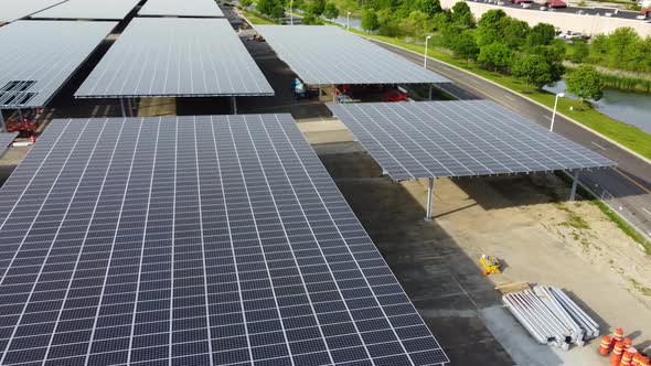 Solar panels installed in a corporate office complex parking lot and solar panels on the office comp alt