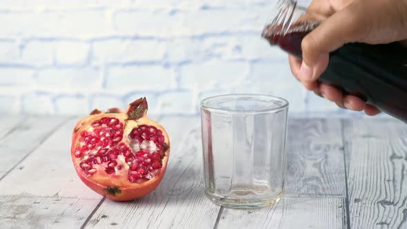 Glass of Pomegranate Juice on Red Background alt