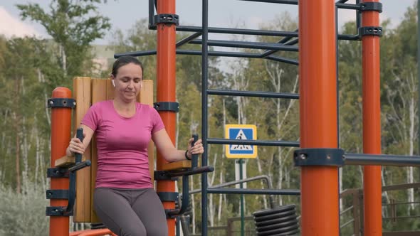Woman Exercising on Chest Press Machine Outdoors alt
