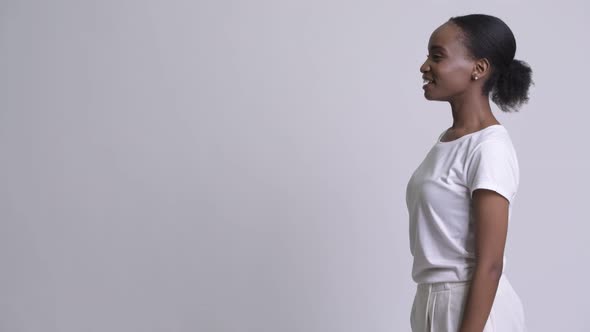 Profile View of Young Happy African Woman Smiling alt