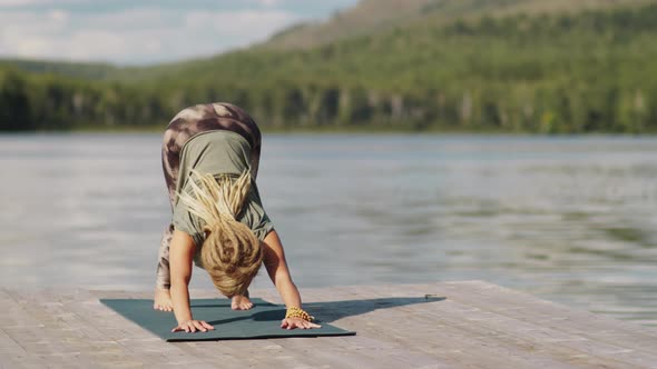 Woman Doing Vinyasa Yoga Outdoors on Summer Day alt