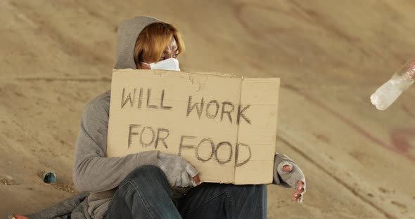 Homeless man holding will work for food label alt