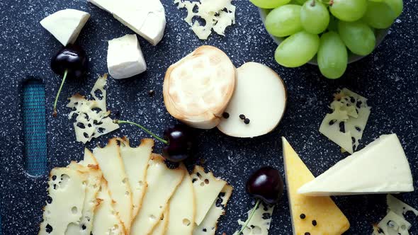 Cold appetizer. Cold cuts. Cheese on cutting board, top view. 4k resolution