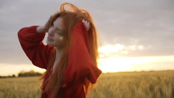 Slow Motion of Romantic Redhead Girl Beautiful Woman with Ginger Hair Wearing Red Dress Smiling