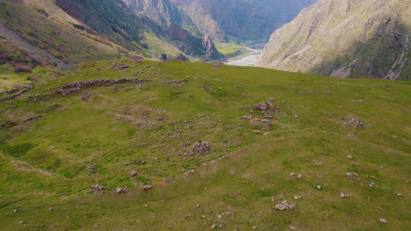 Closeup Aerial View of a Mountain Meadow and Dariali Gorge in the Distance Georgia alt